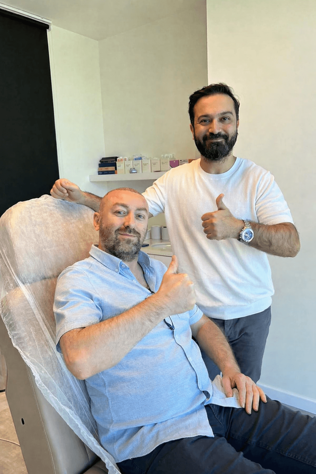 Dr. Gökeşme with a patient immediately following their hair transplant procedure.
